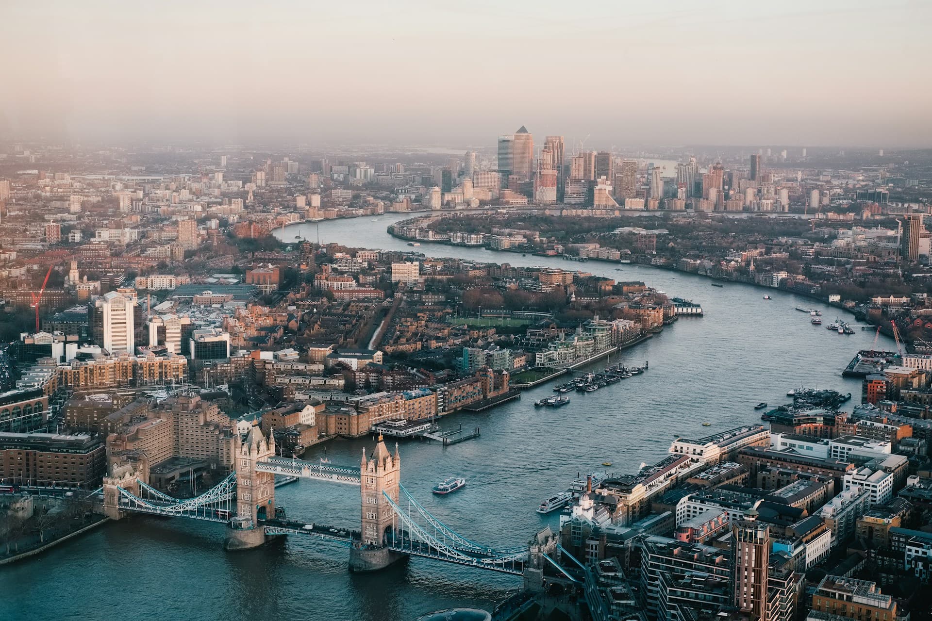 London skyline at dusk — Thames and central towers suggesting institutional scale